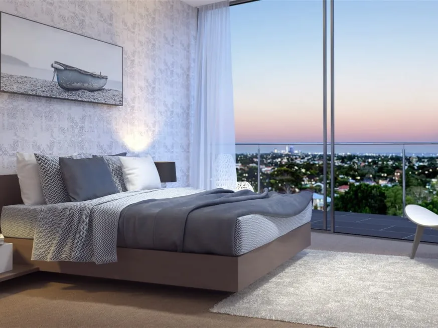 Hotel guest room with carpeted floor and a view over Perth at dusk